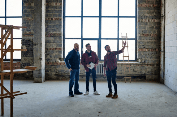 young foreman or contractor pointing at brick wall 4A838AX 1024x683 1